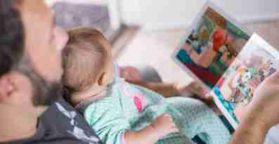En förälder läser en bok för sin bebis
